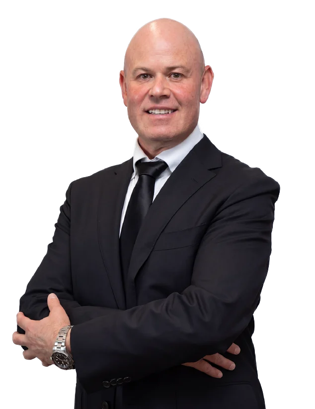 Paul Goldin in a dark suit with arms folded