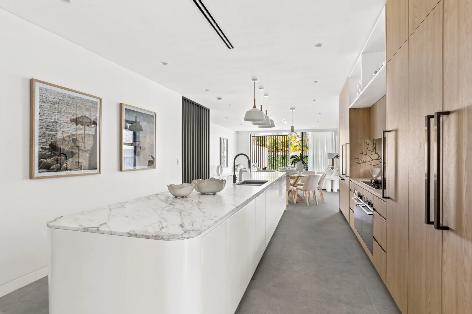 Kitchen with a marble island and timber joinery
