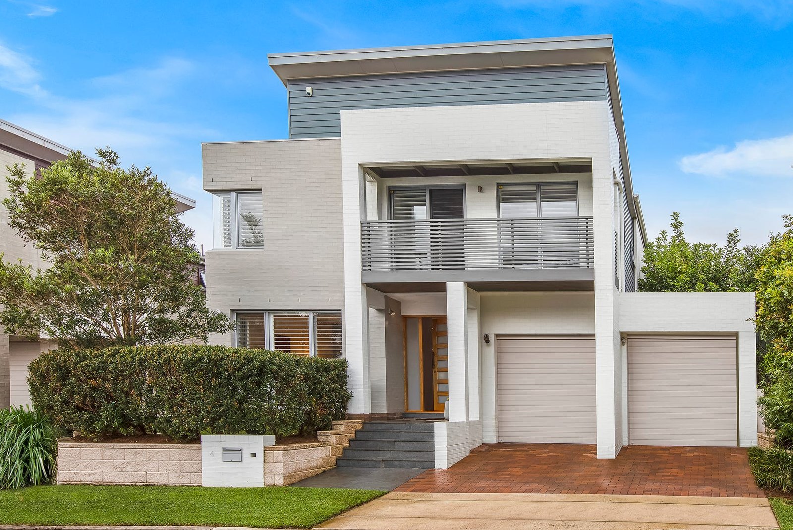 Contemporary two-storey home with a balcony and double garage