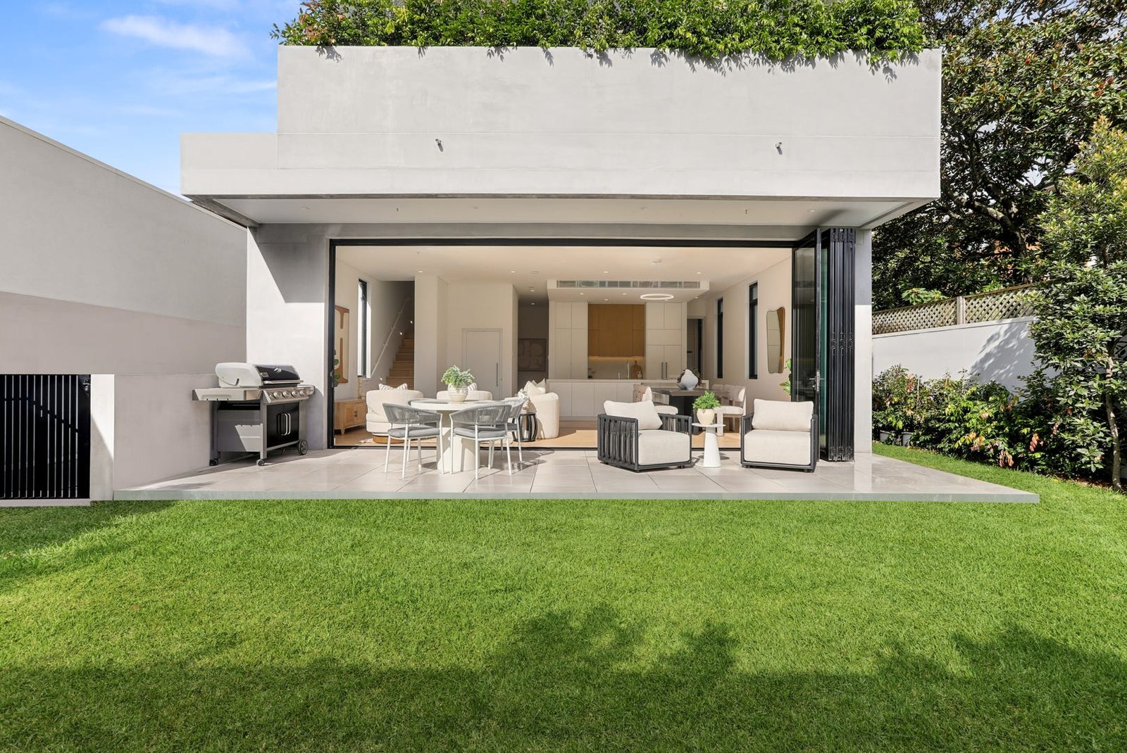 Contemporary home opening onto a terrace and lawn